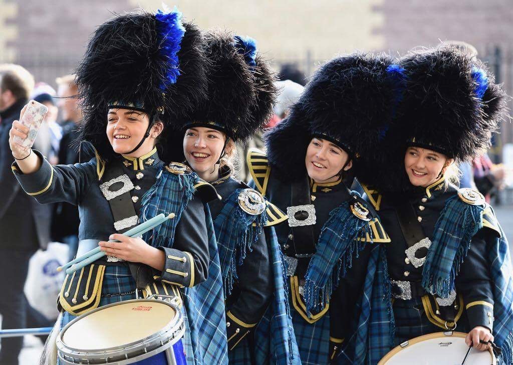 Image shows RAF Pipes and Drummers taking a selfie with mobile phone device. 